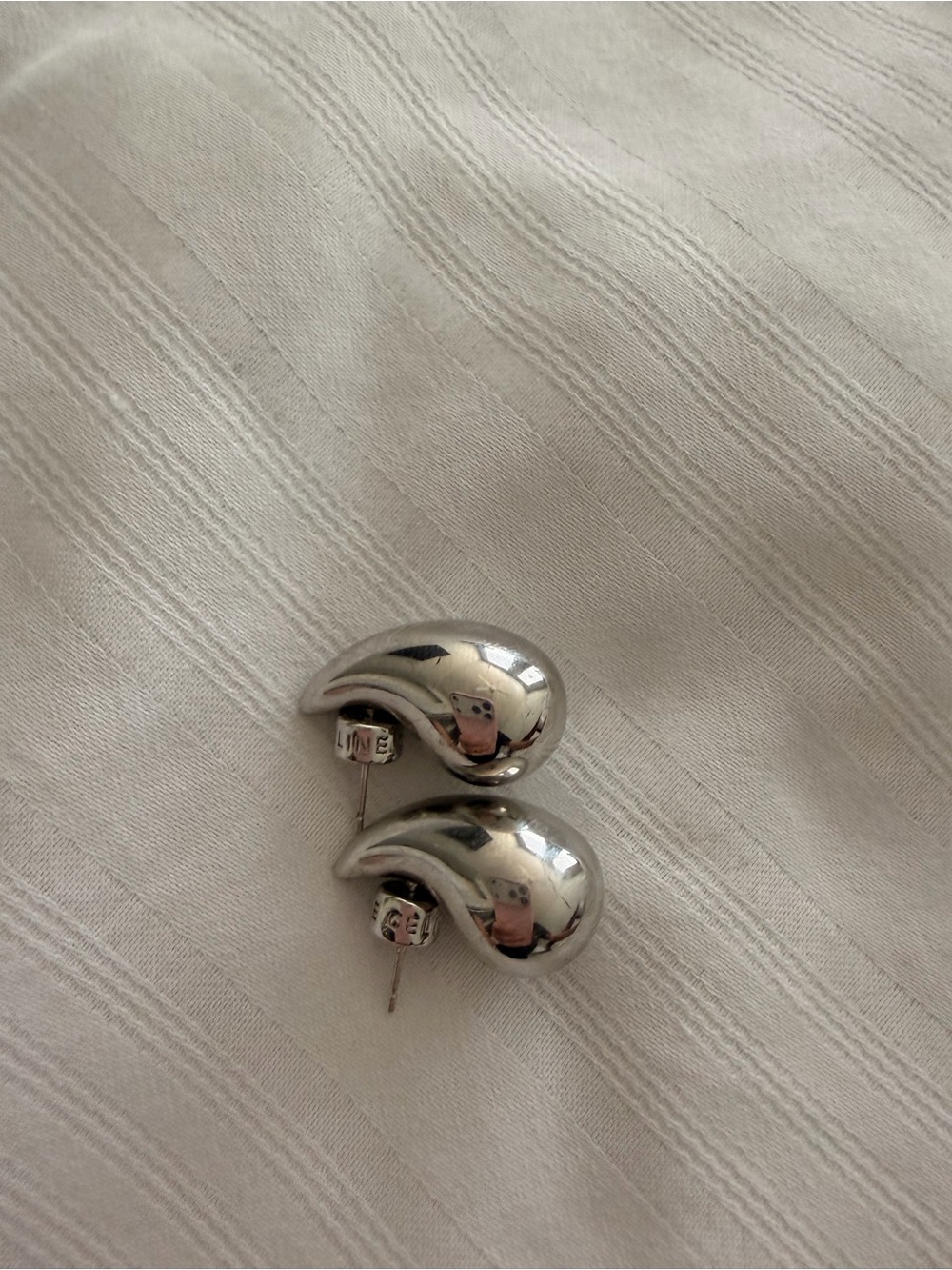 Sleek Silver Curved Drop Stud Earrings